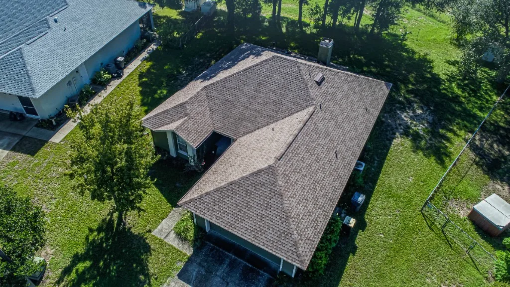 Aerial view of a completed Stronghold Roofing warm brown architectural shingle roof on a Florida single-story home
