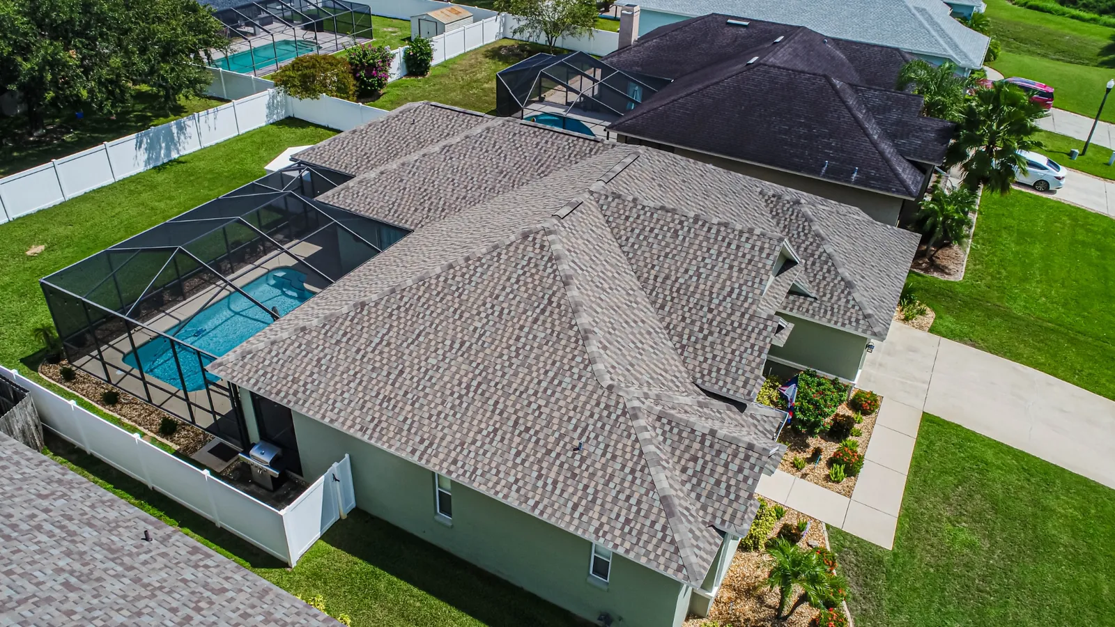 Aerial view of a completed Stronghold shingle roof replacement in a Florida neighborhood
