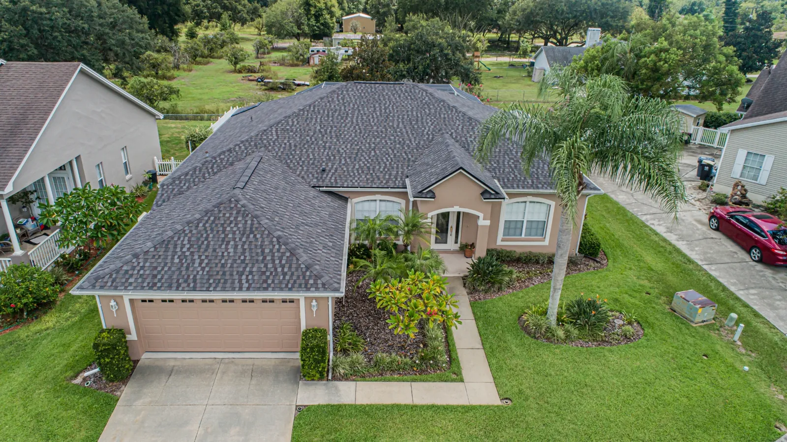Aerial view of a Stronghold shingle roof replacement on a Florida lakefront home