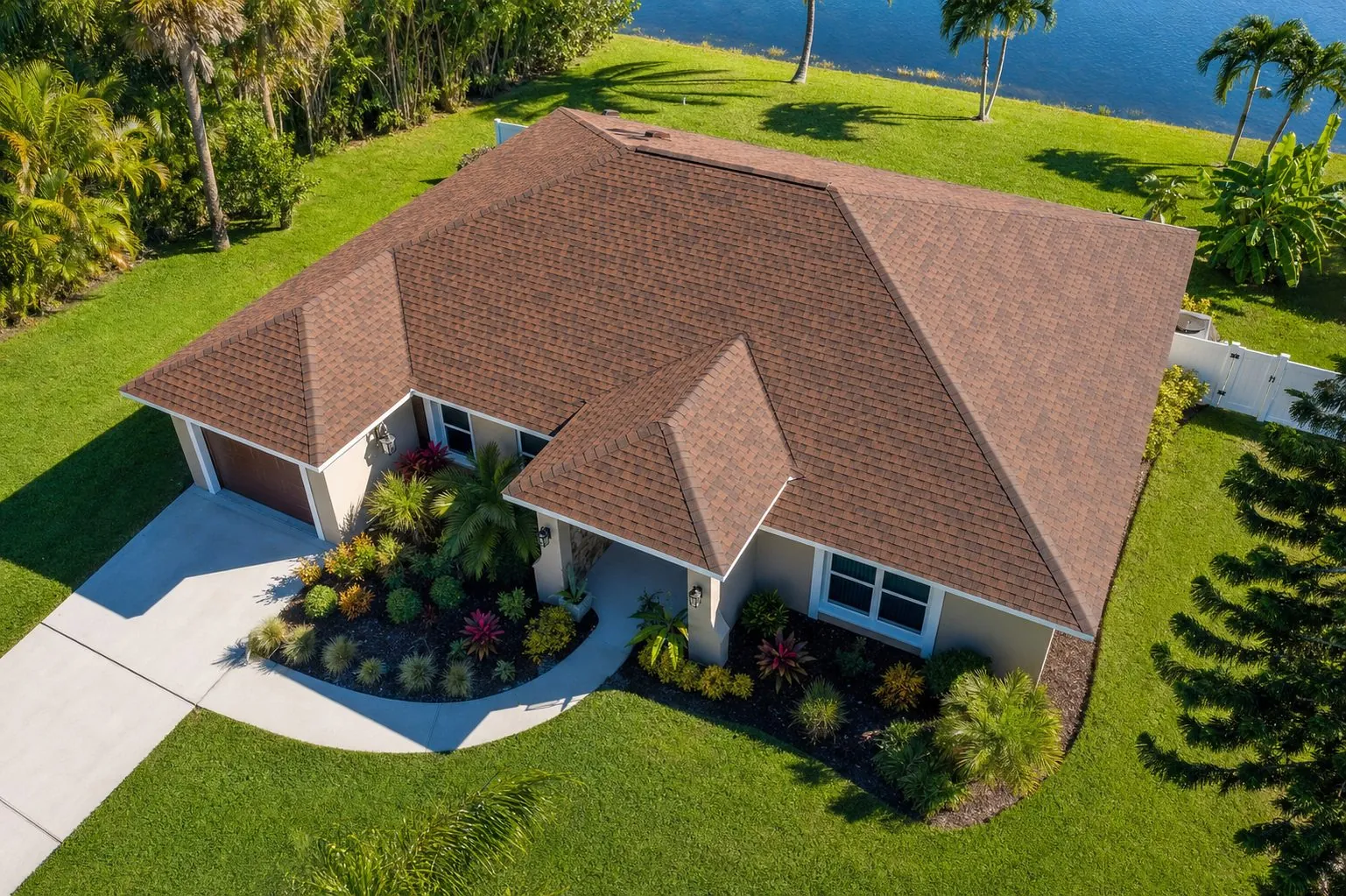 Warm brown architectural shingles on a Florida ranch home, drone view
