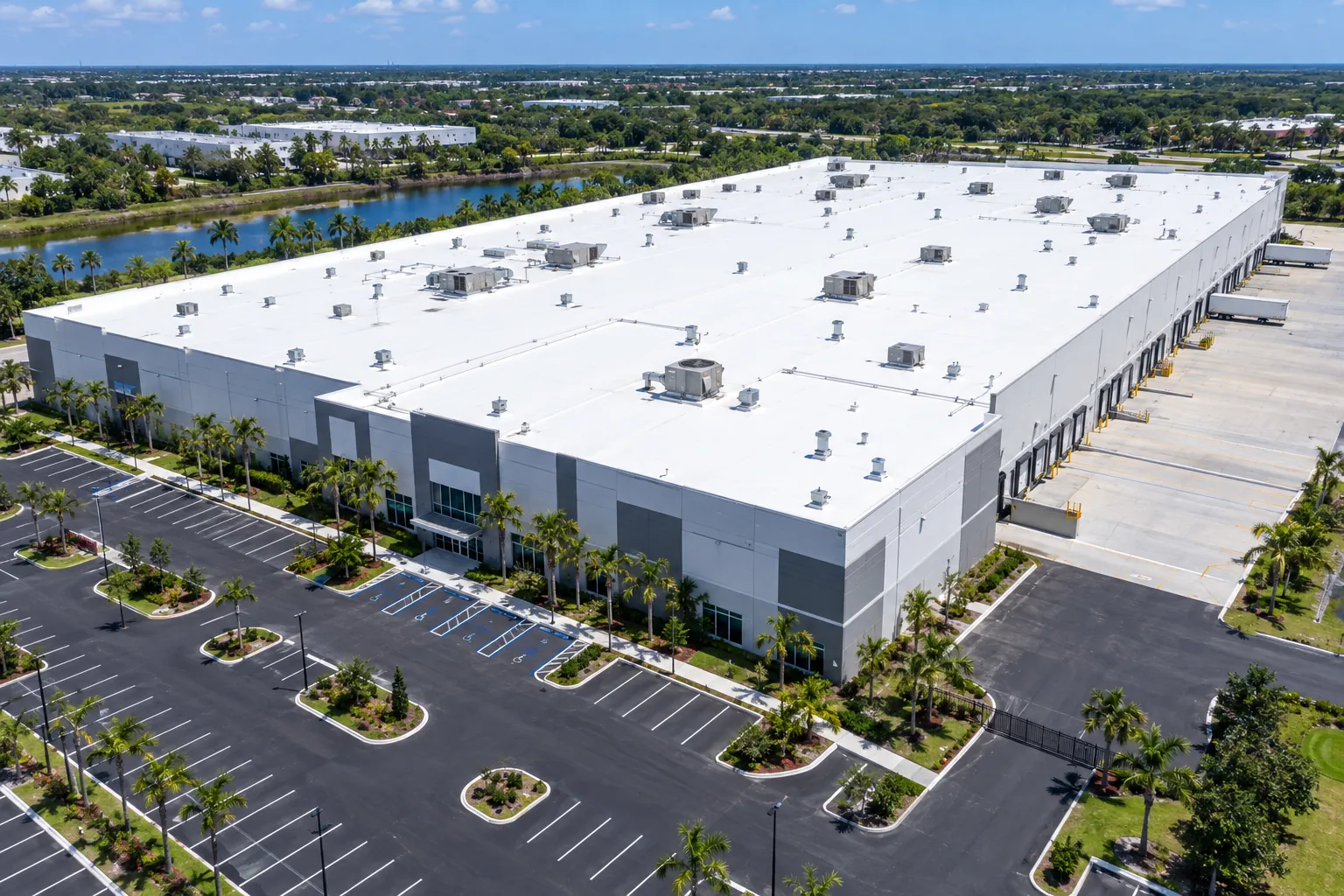 Aerial view of a large Florida distribution center with a bright white TPO flat roof