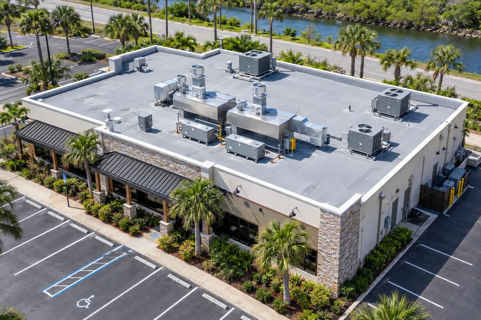 Aerial view of a Florida restaurant with a gray PVC flat roof and kitchen exhaust hoods