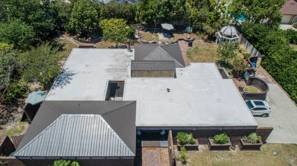 Stronghold Roofing installed a dark gray metal roof on this two-story home in Clearwater, FL.