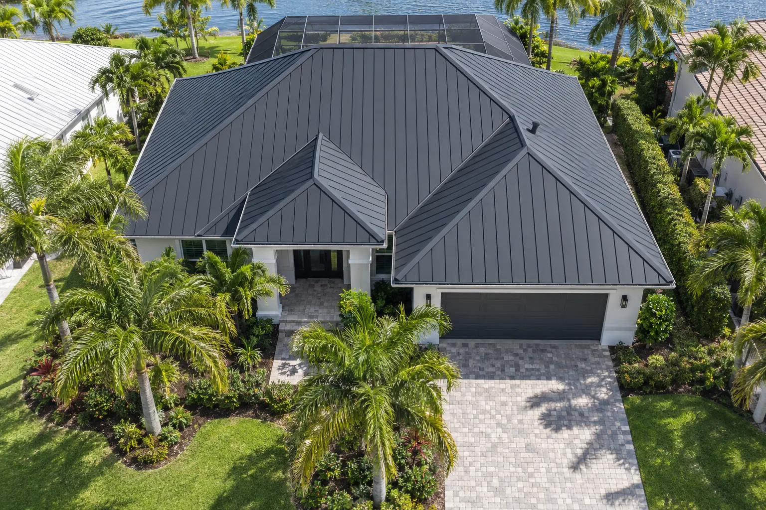 Aerial view of a dark charcoal standing seam metal roof on a Florida lakefront home