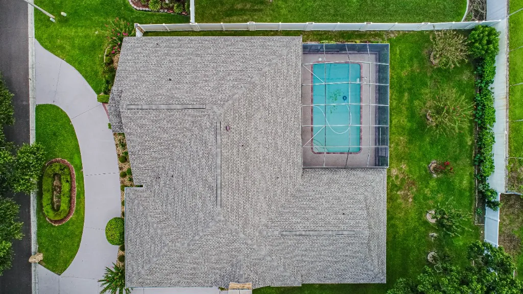 Stronghold Roofing completed a gray shingle roof on a ranch house with a screened pool cage in Bartow, FL.