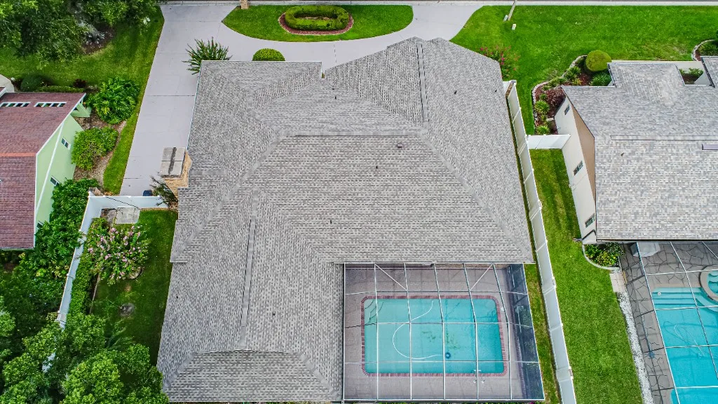 Stronghold Roofing installed a gray shingle roof on a ranch-style home with a screened pool cage in Plant City, FL.