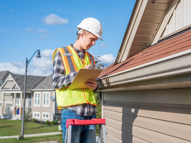 Roof inspector inspecting a roof