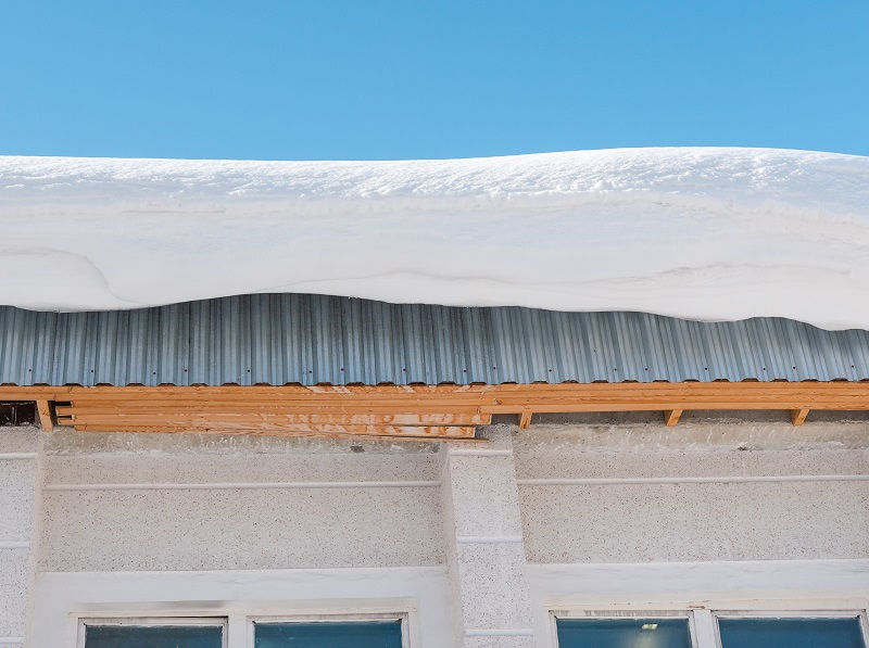 heavy snow on flat roofs