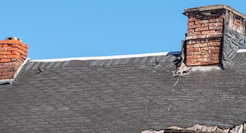 damaged shingles near chimneys