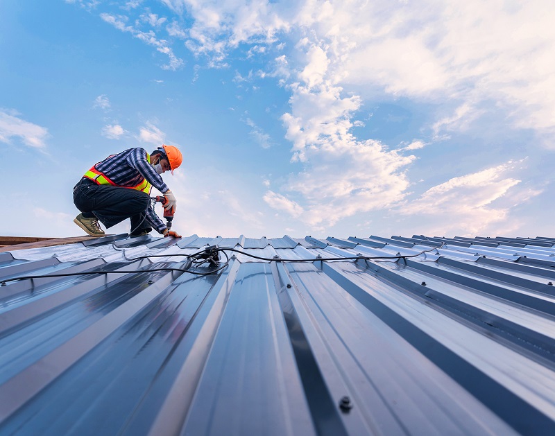 Pro roofer installing a metal roof