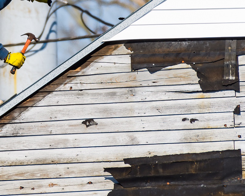 Roofers repairing hurricane roof damage