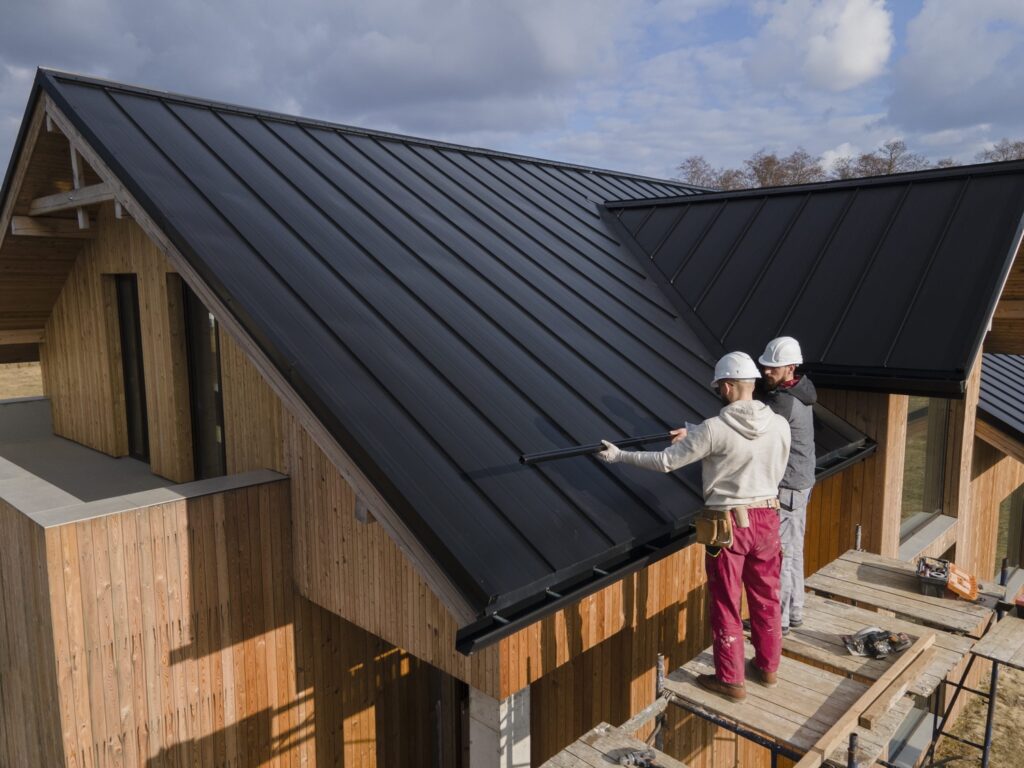 2 man working on black roof in and near Florida