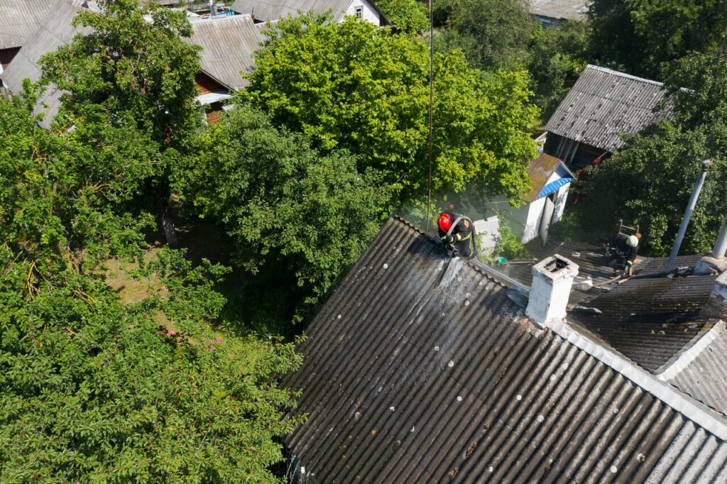 A Lakeland roof professional on the roof inspecting hail damage