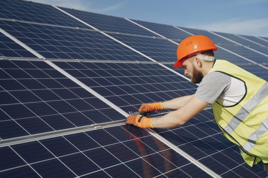 A roofer installing solar panel in and near Lakeland