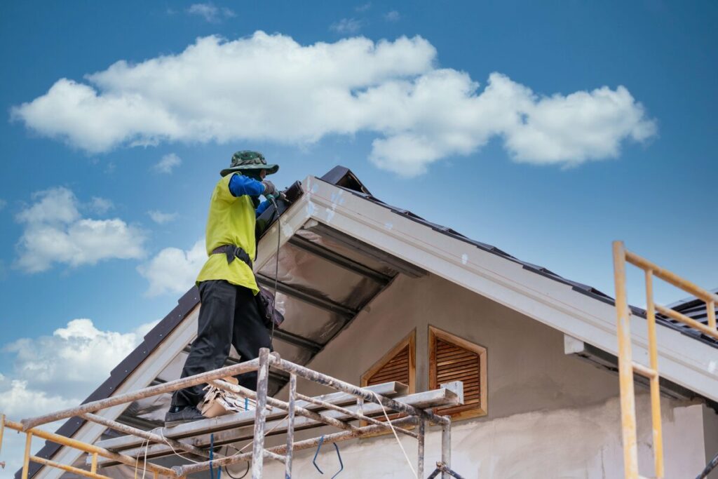 A roofer patching an old roof in Lakeland