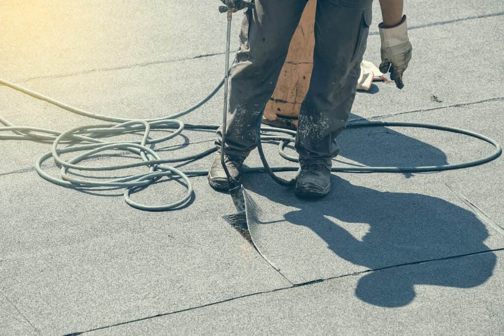 a roofer inspecting a commercial roofing in Lakeland