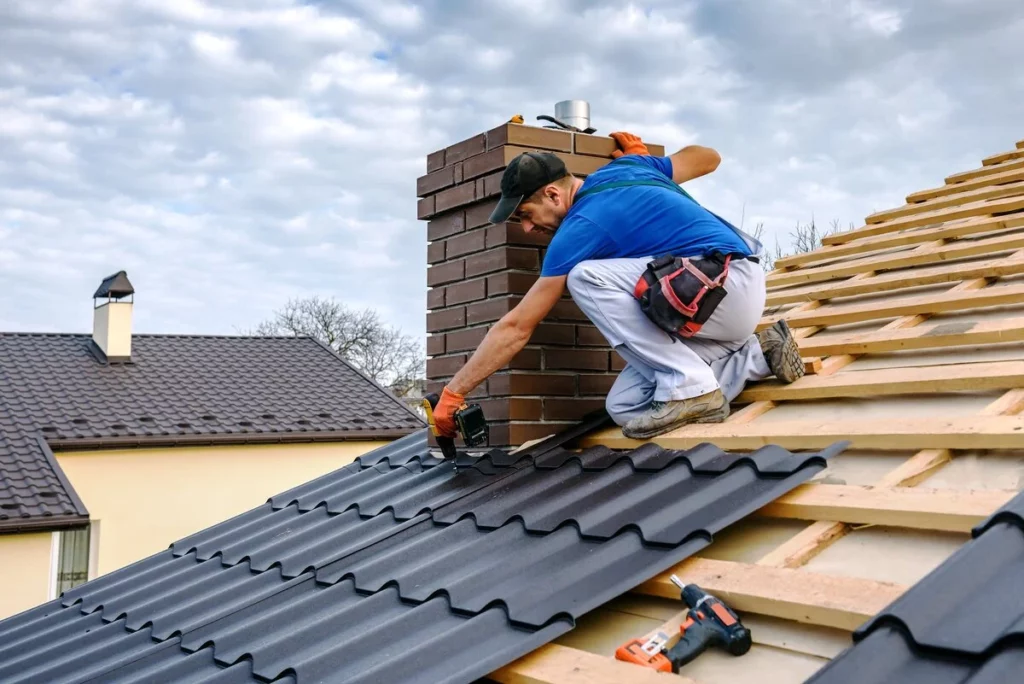 A man installing roof near chimney which needs more attention