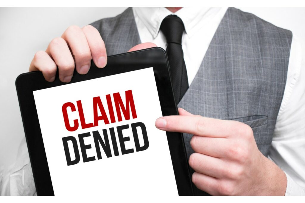 a man holding a tablet says claim denied